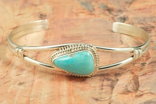 Genuine Castle Dome Turquoise set in Sterling Silver Bracelet. The Castle Dome Turquoise Mine is located about 30 miles from the Sleeping Beauty Mine, near Globe, Arizona. The Castle Dome Mine has not been in operation since the early 1970s.
 Created by Navajo Artist Larson Lee. Signed by the artist.